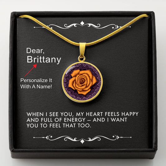 Gold necklace with an orange rose pendant in a box with a message card that can be personalized.