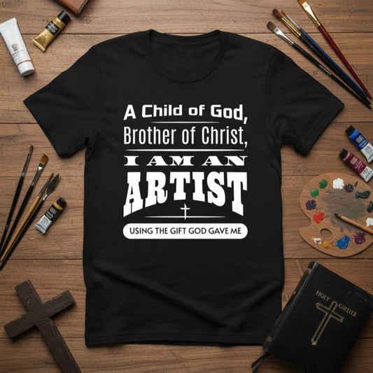 Black t-shirt with white text on a wooden surface with art supplies