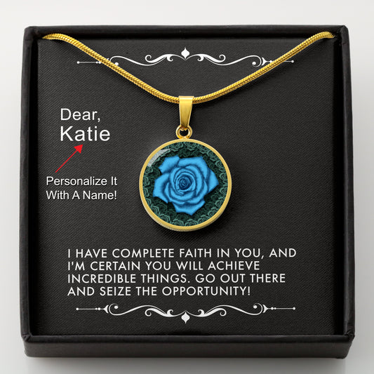 Gold necklace with a blue rose pendant in a box with a message card that can be personalized.