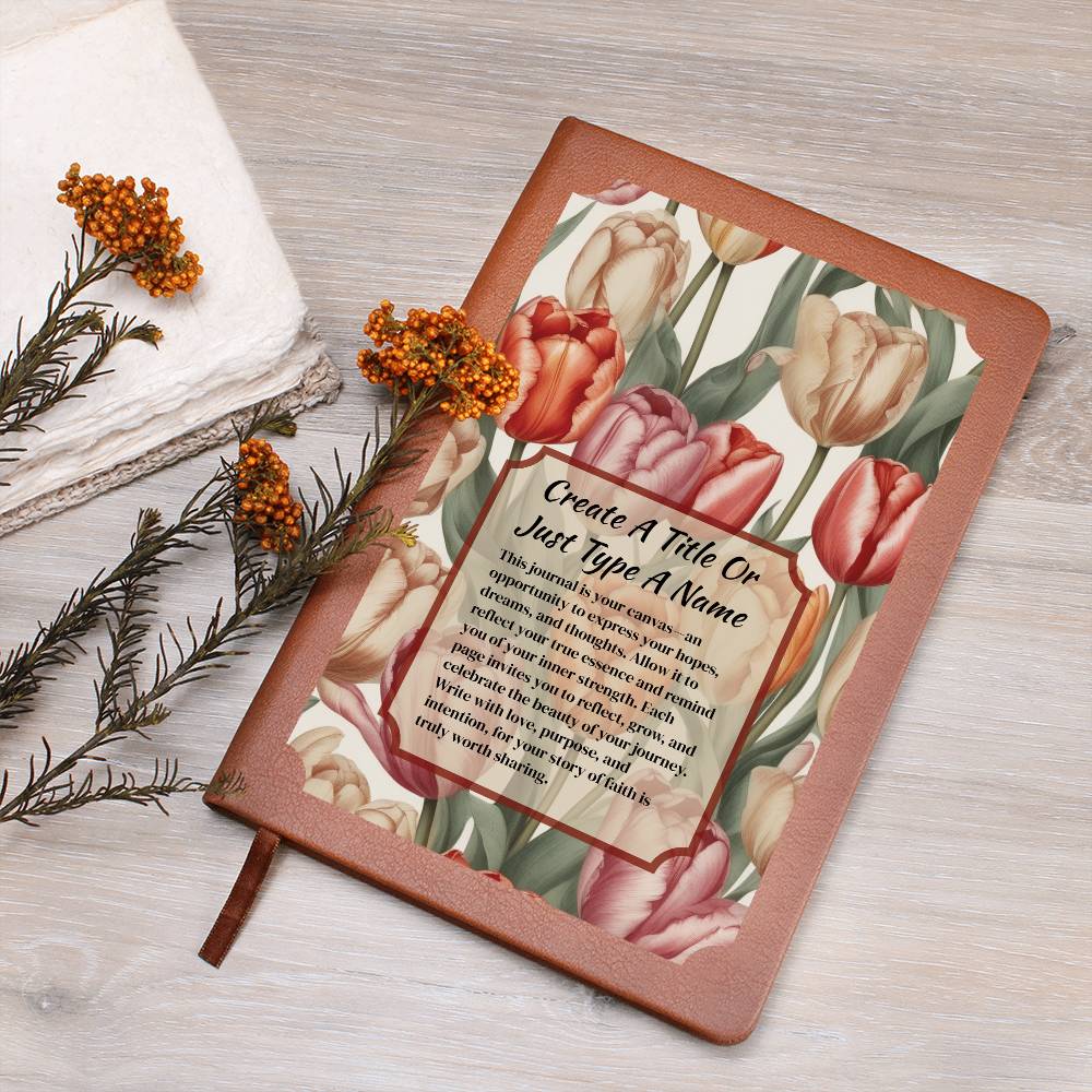 Vegan leather journal with a floral design on the cover, featuring text, red-orange, and pink tulips on a wooden surface.