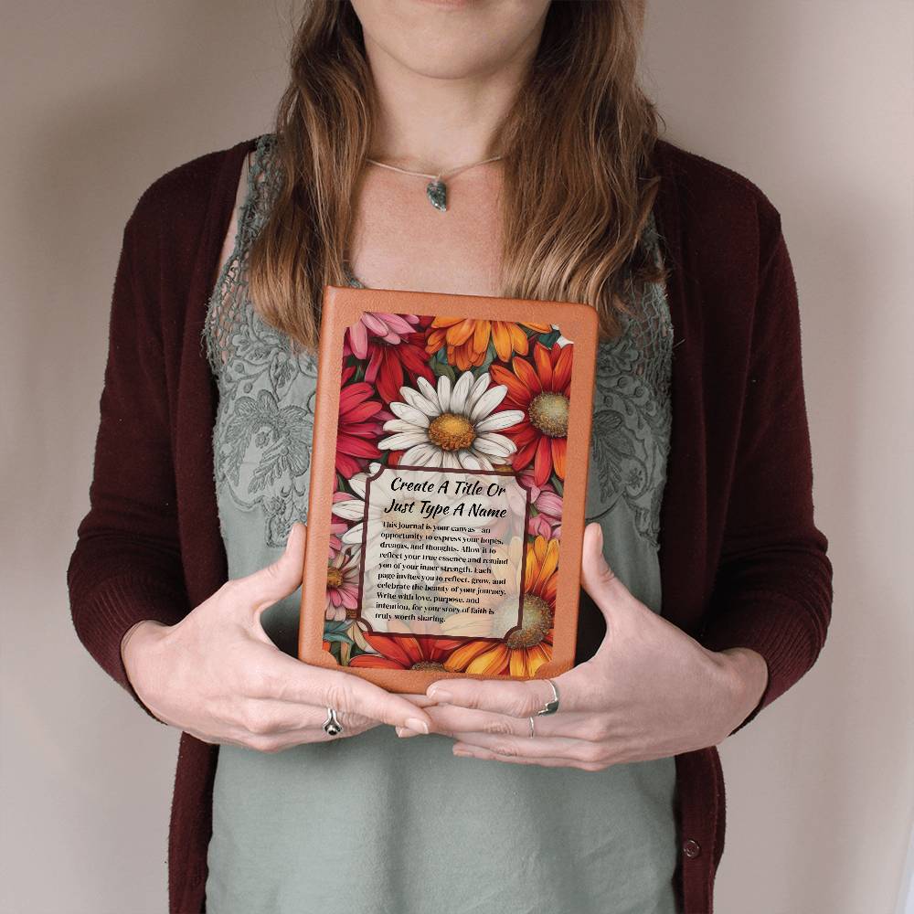 Person holding colorful daisies on a vegan leather journal with text.