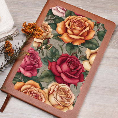 Roses and leaves design on a vegan leather journal cover on a wooden surface.