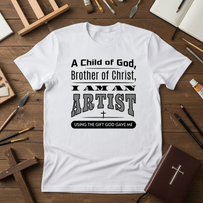 White t-shirt with text on a wooden table with art supplies