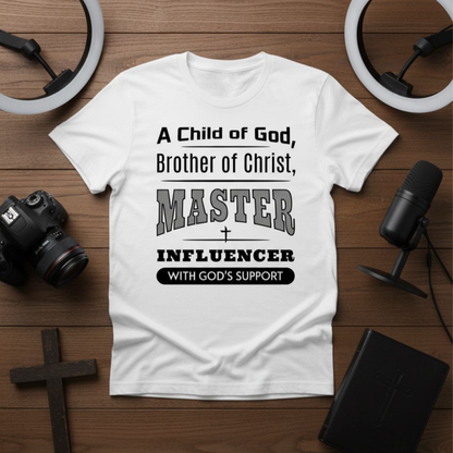 White t-shirt with text on a wooden surface with camera, microphone, and cross.