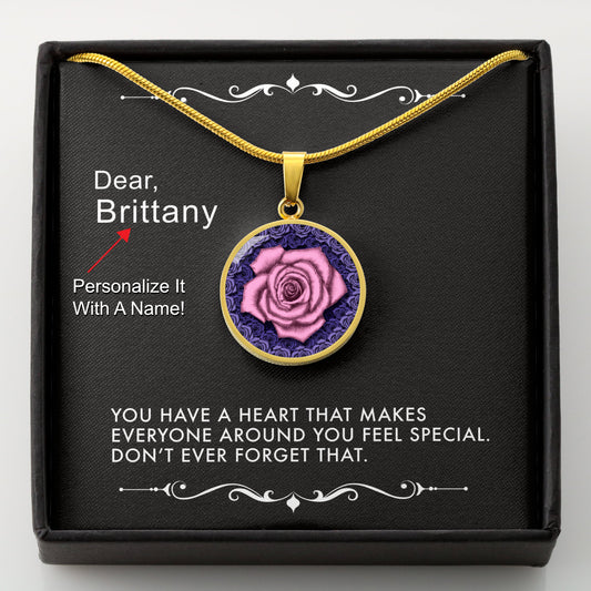 Gold necklace with a pink rose pendant in a box with a message card that can be personalized.