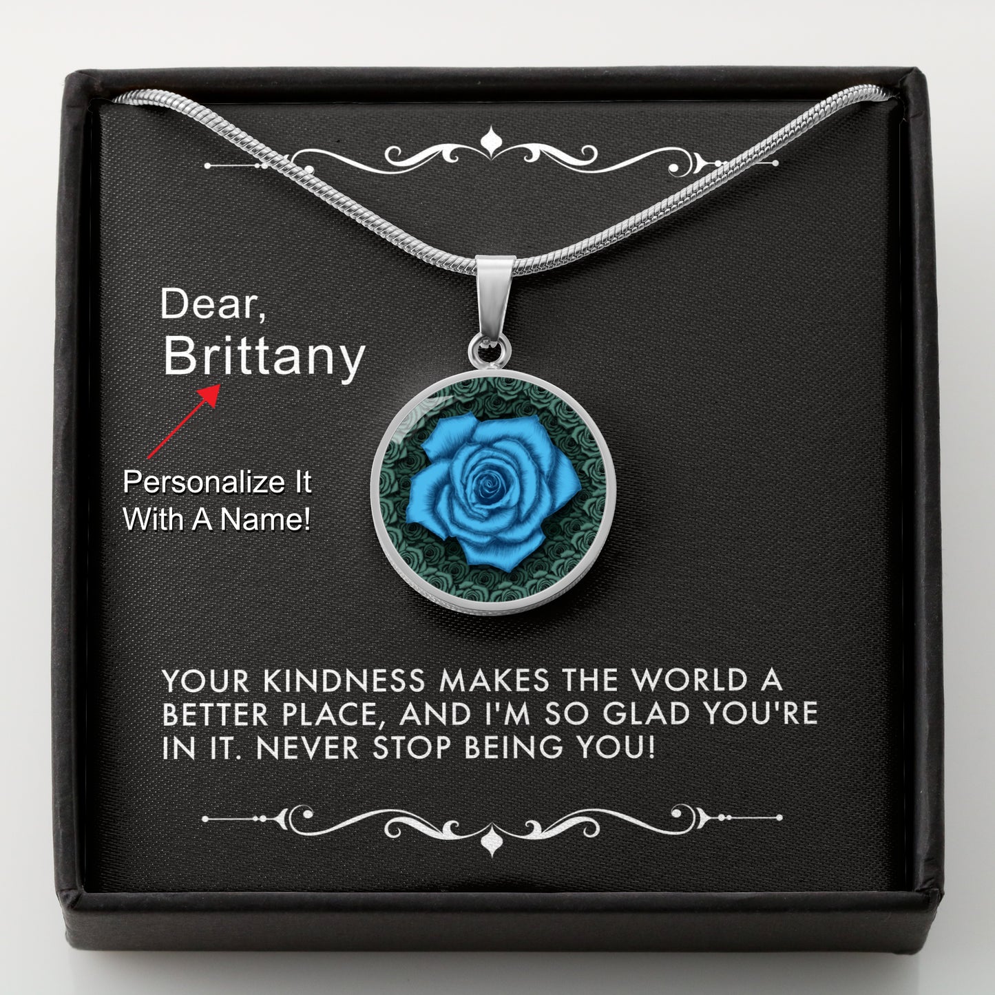 Silver necklace with a blue rose pendant in a box with a message card that can be personalized.