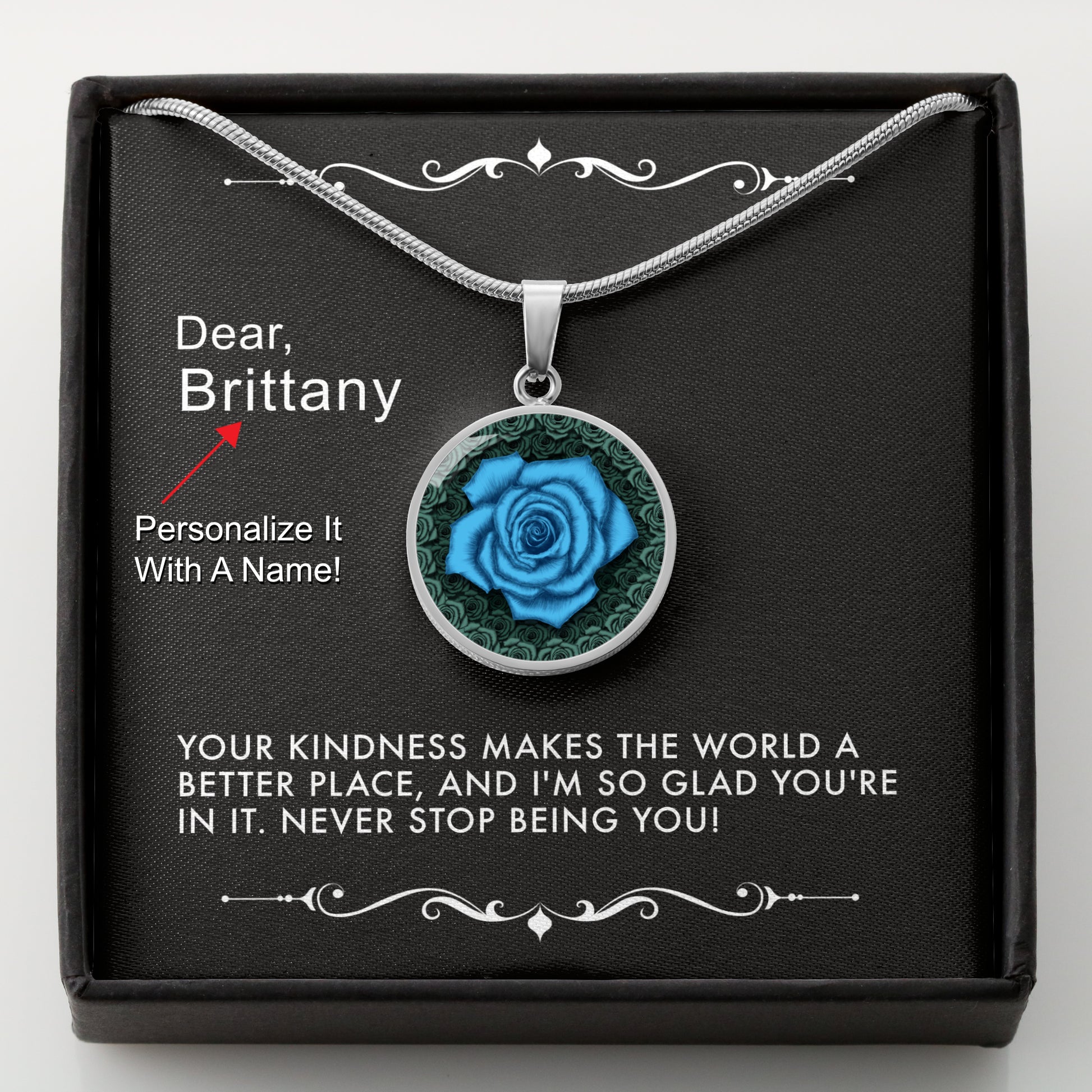 Silver necklace with a blue rose pendant in a box with a message card that can be personalized.