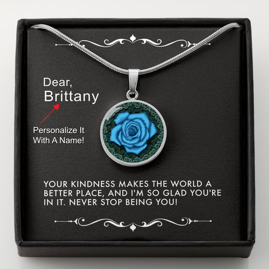 Silver necklace with a blue rose pendant in a box with a message card that can be personalized.