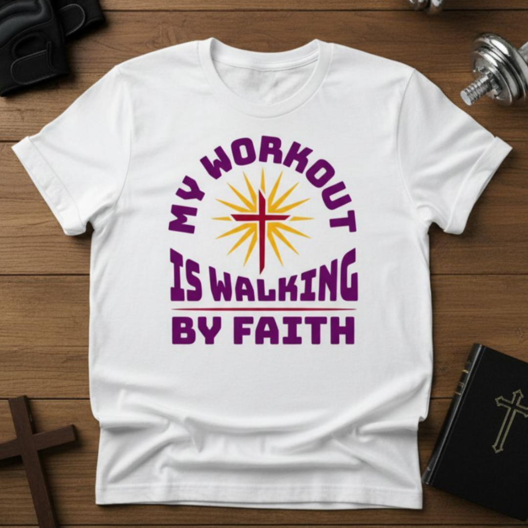 White t-shirt with 'My Workout is Walking by Faith' design on a wooden surface.